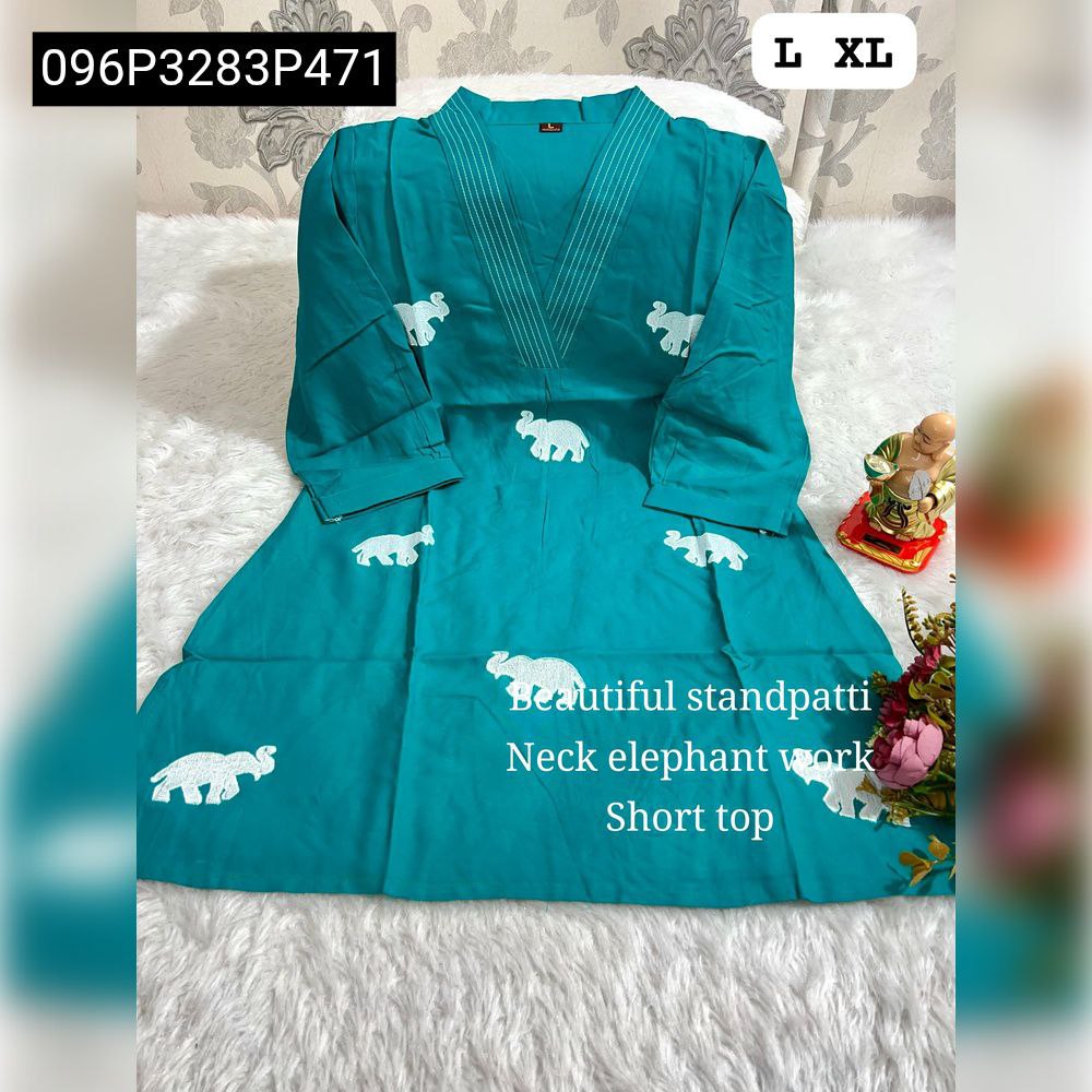 TRENDBUY Pure Soft Roman Cotton designer top in Teal Blue with white elephant embroidery and V-neck pattern, laid flat.