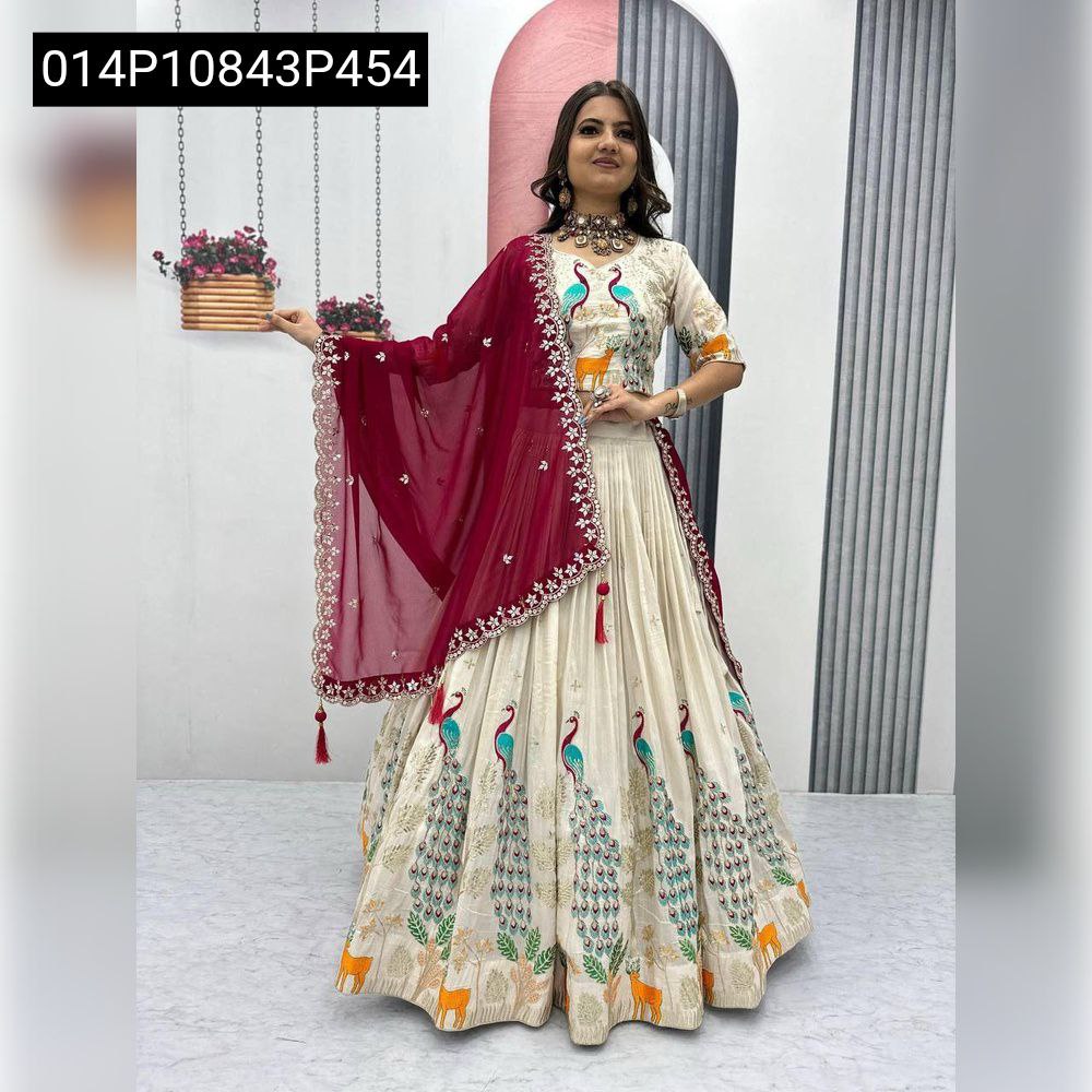 Full body shot of model standing confidently in an off-white Pure Tissue Silk lehenga choli featuring intricate peacock and deer embroidery, complemented by a heavy work maroon Fox Georgette dupatta.