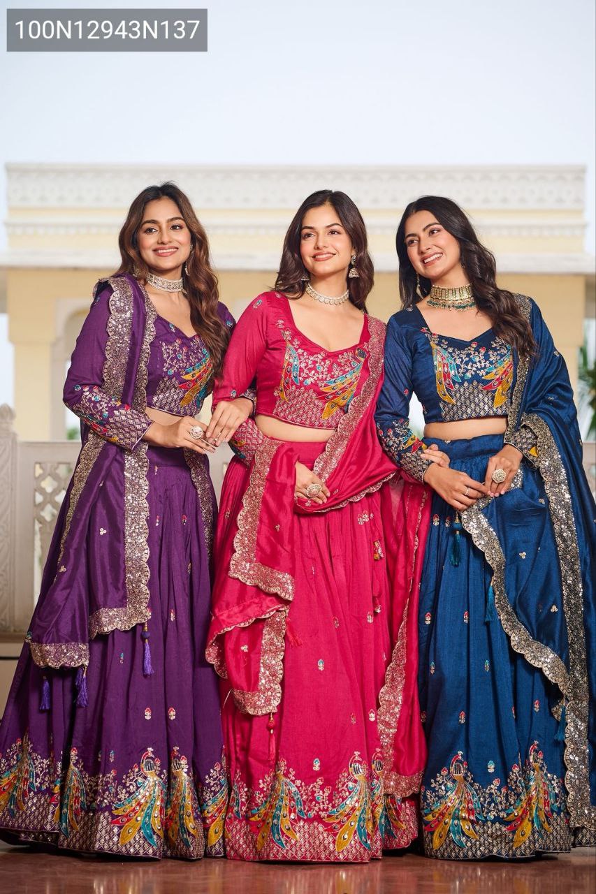 Three models showcasing TRENDBUY Lehenga Choli sets in Rani Pink, Royal Purple, and Navy Blue, standing together elegantly, highlighting color variants and embroidery.