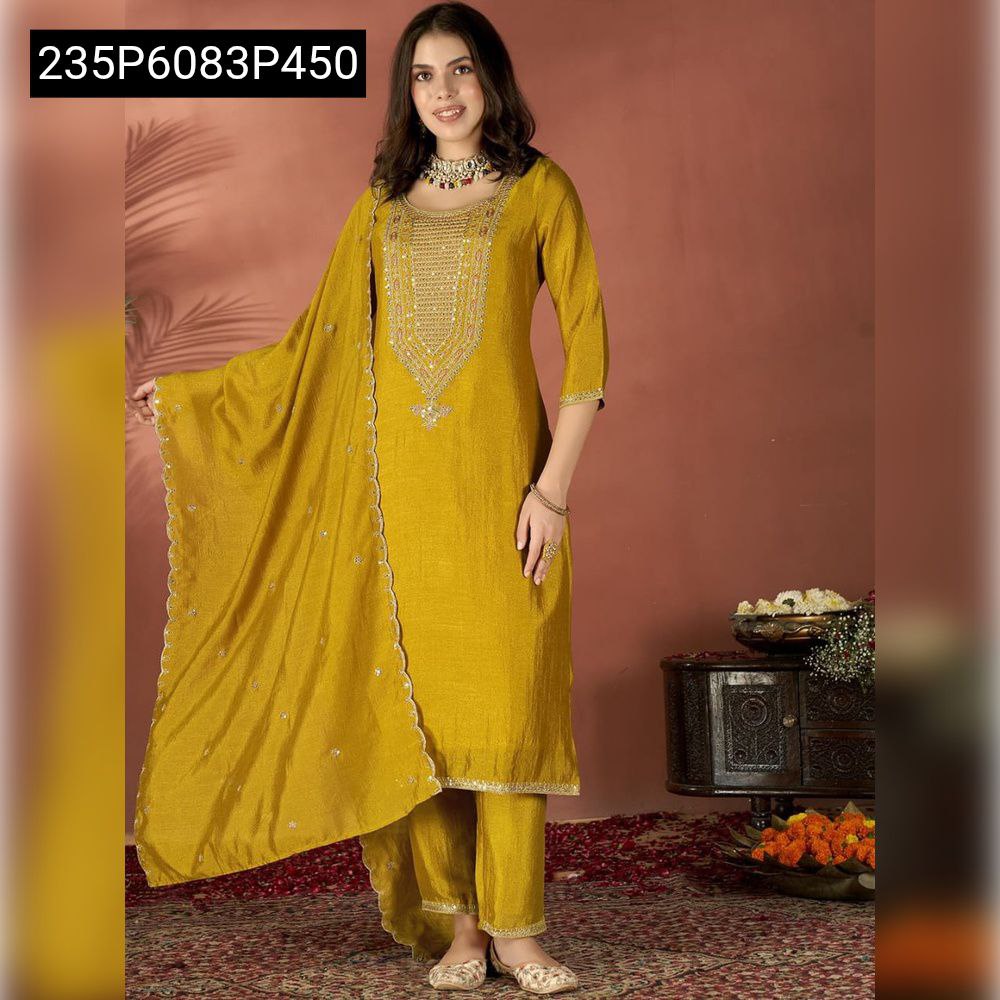 Full body shot of a model wearing a mustard yellow pure Vichitra silk kurti set with an elegantly draped, embroidered dupatta, set against a warm-toned background.