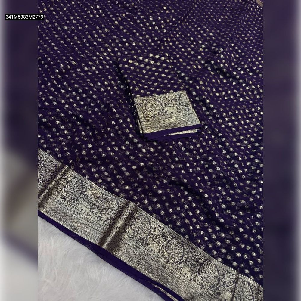 TRENDBUY Pure Viscose Georgette saree in rich dark purple with gold zari polka dots and intricate gold jacquard elephant border, folded with matching blouse piece.