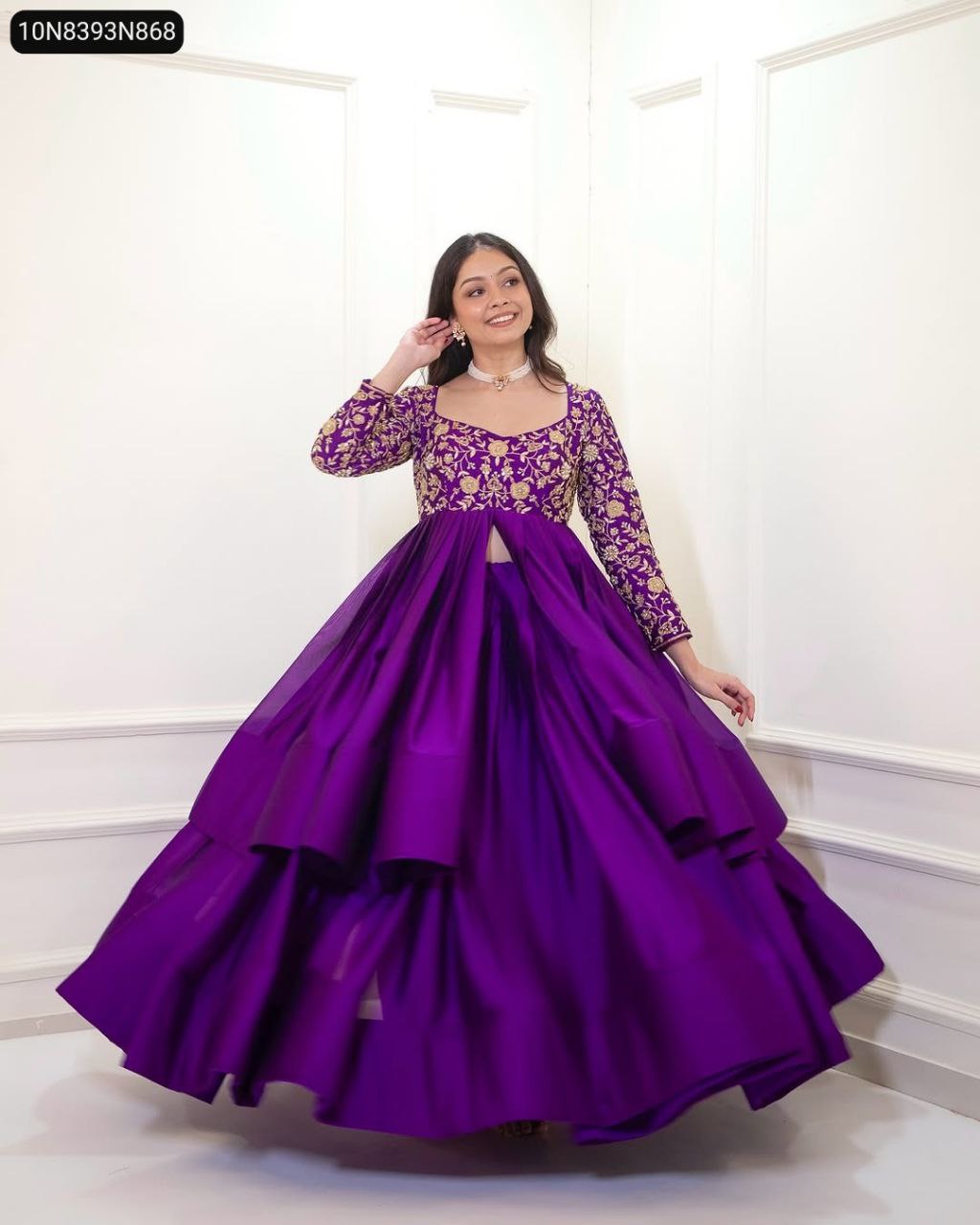 Smiling model in TRENDBUY Purple Chinon Silk Peplum Lehenga Set, twirling gracefully, full body shot in a white room.