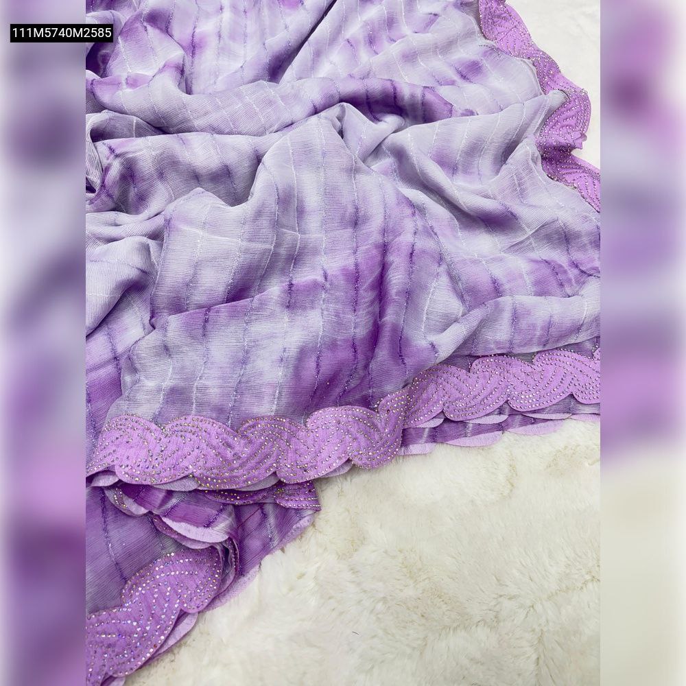 TRENDBUY Purple shimmer georgette silk saree, unfolded to display its tie-dye pattern and designer siroski cutwork lace border with sequins, draped on a white textured surface.