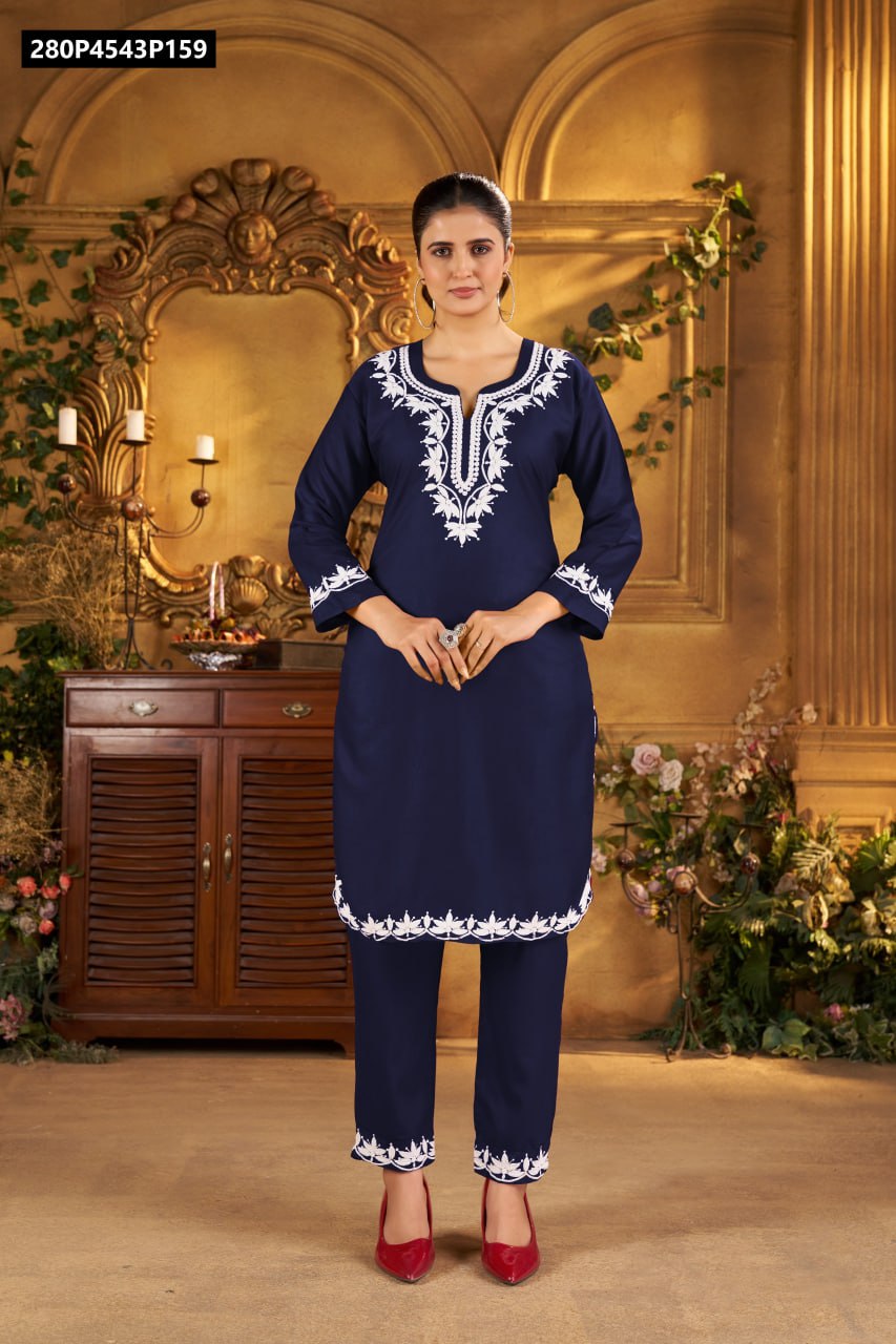 Full body shot of model in navy blue rayon kurti and matching embroidered pants, standing.