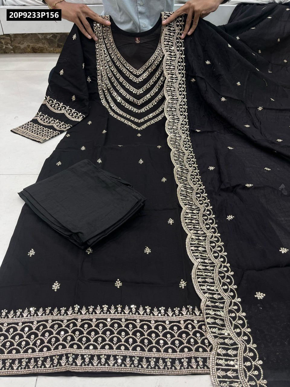 Model wearing TRENDBUY stunning Red Shimmer Chanderi Silk Party Suit with intricate golden embroidery, flowing matching dupatta, perfect for festive occasions and celebrations.