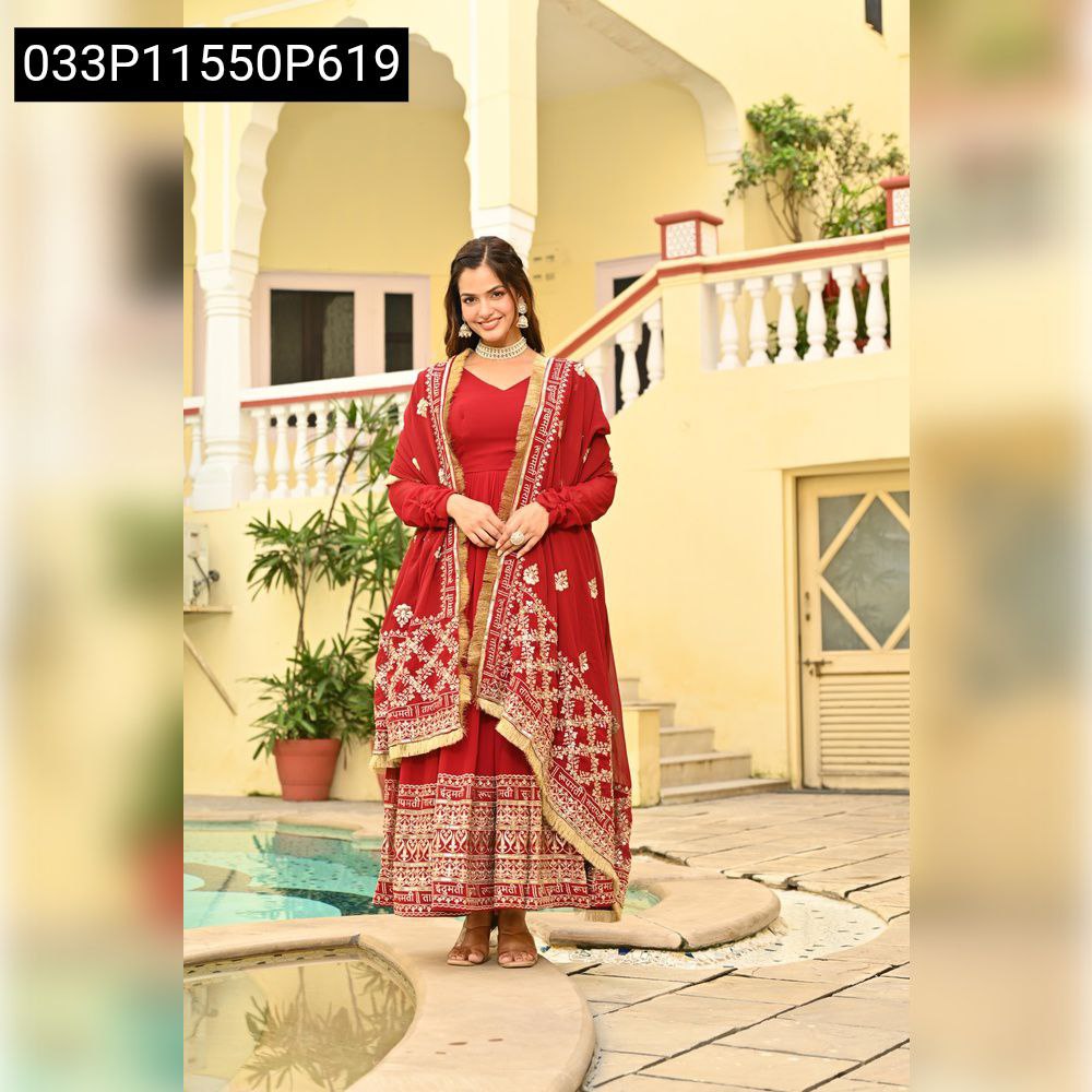 Model in a vibrant red TRENDBUY embroidered faux blooming gown with dupatta, standing by a pool in a courtyard setting.