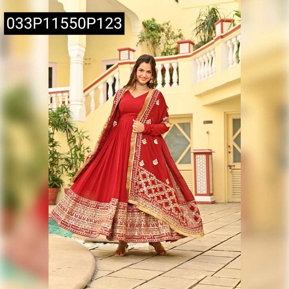 TRENDBUY model in red faux blooming gown with zari sequins embroidery, flowing gracefully outdoors.
