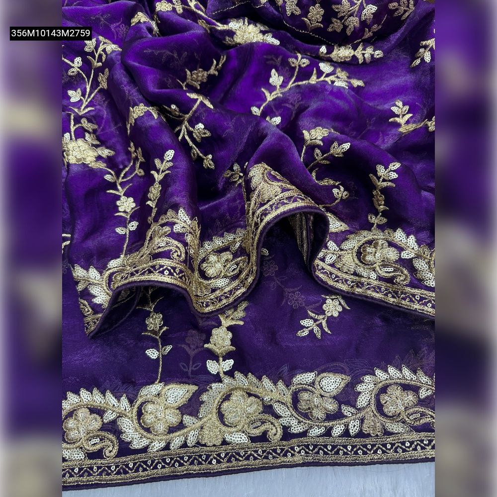 Close-up of flowing purple space silk saree fabric with intricate golden sequence and Zari floral embroidery on the pallu and border.