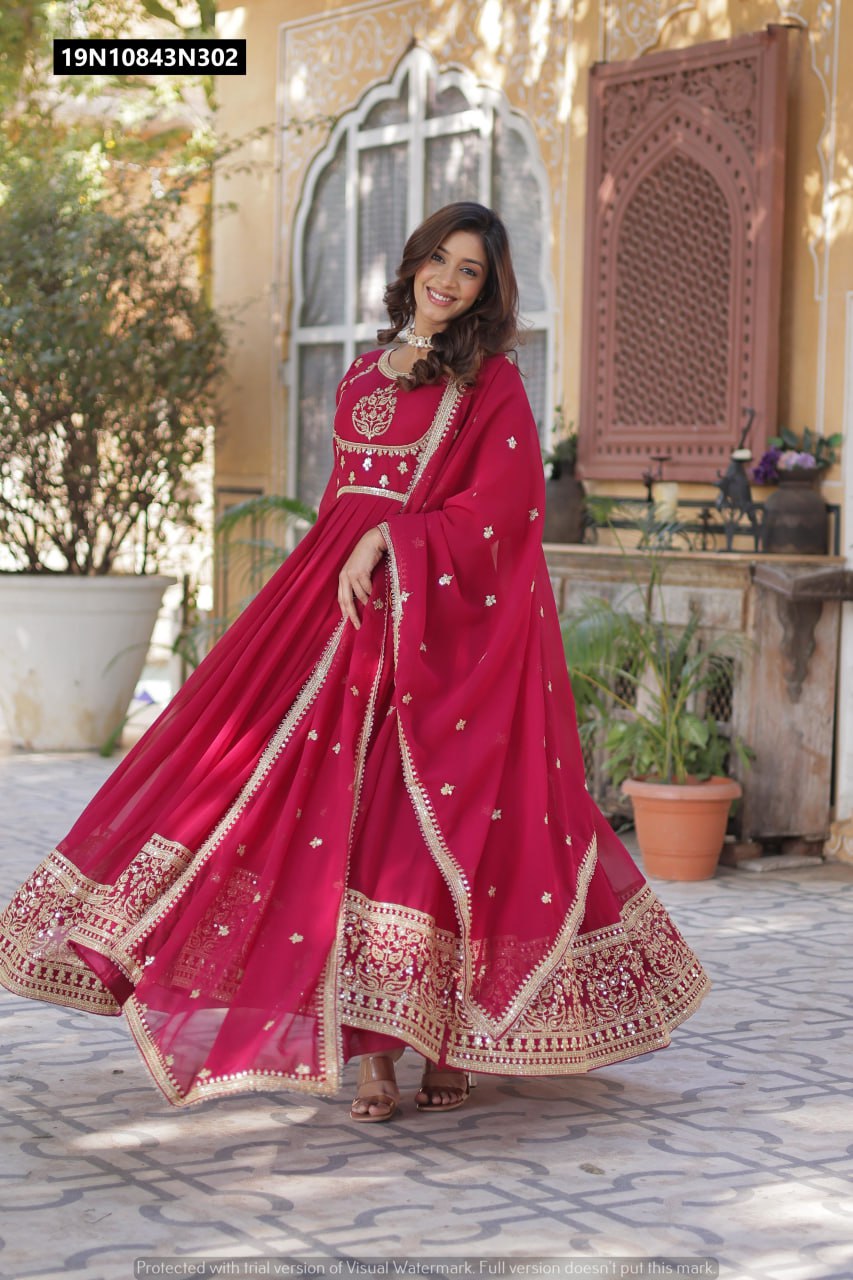 Full body shot of model in a vibrant wine red sequin embroidered georgette gown with matching dupatta, twirling to display the generous 3.5 MTR flair.