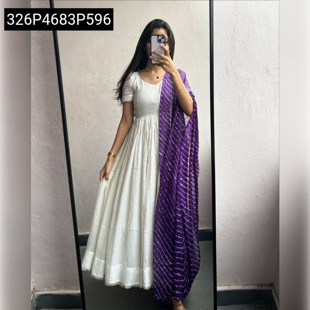 TRENDBUY model in full length white shimmer chiffon gown with short sleeves and vibrant purple leheriya print dupatta, reflected in a mirror.