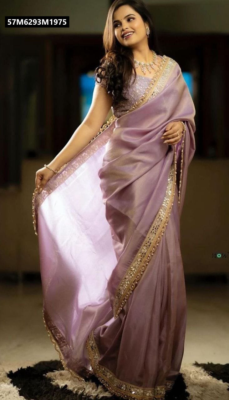 TRENDBUY woman in luminous lavender shimmering net saree with heavy mirror work border, smiling elegantly