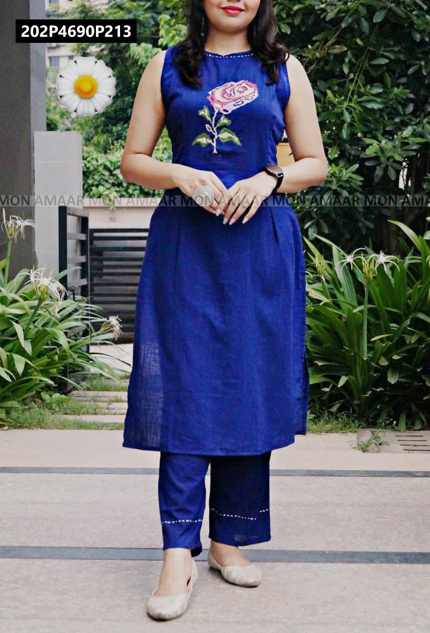 Full body shot of a woman in a royal blue sleeveless flex cotton kurti with rose embroidery and matching pants, outdoor setting.