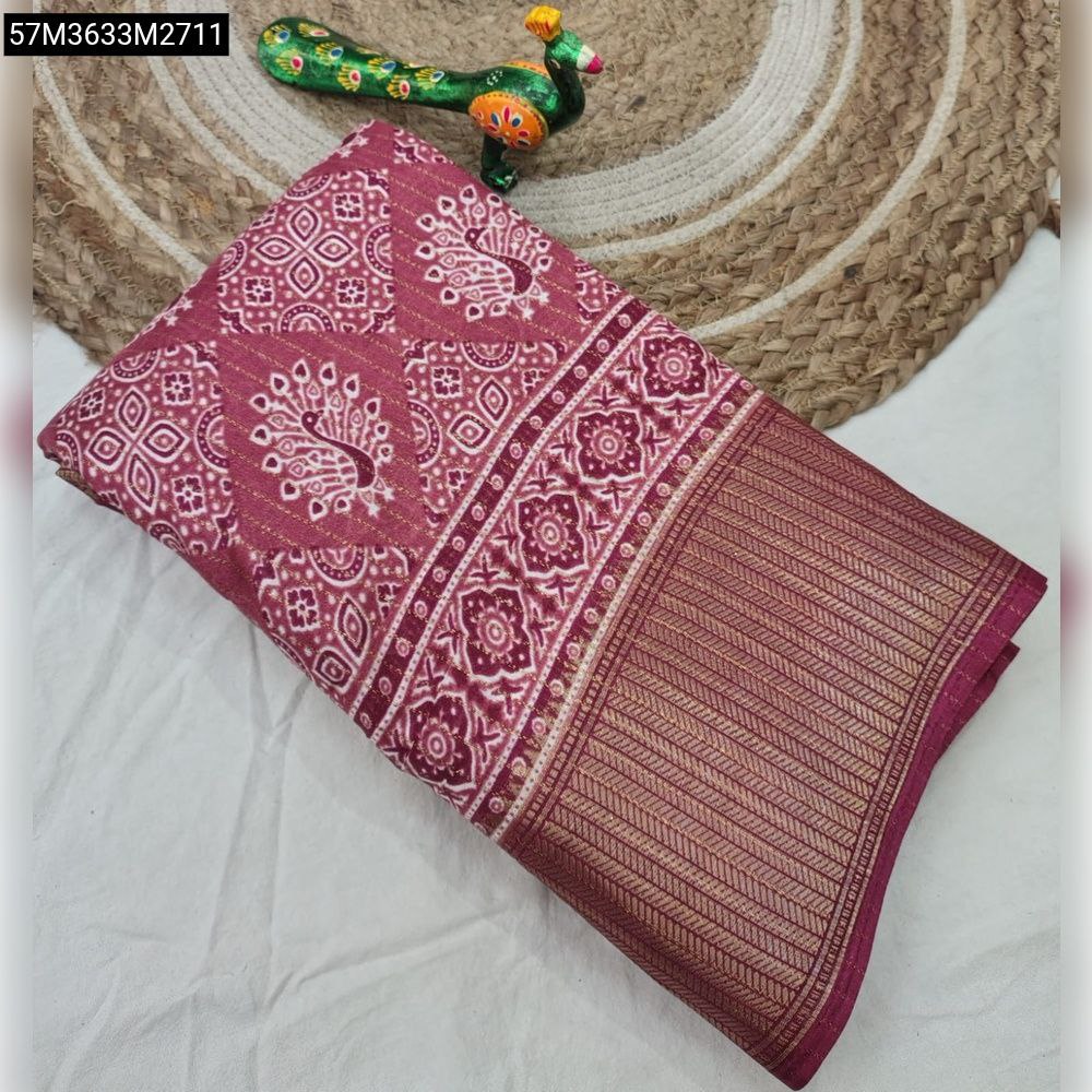TRENDBUY Maroon Soft Dola Silk Saree with detailed gold jari border and intricate white peacock floral print, folded on a rustic mat.