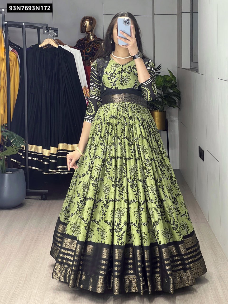 Full body shot of model wearing TRENDBUY Olive Green soft silk floral print maxi gown with jacquard border, standing gracefully