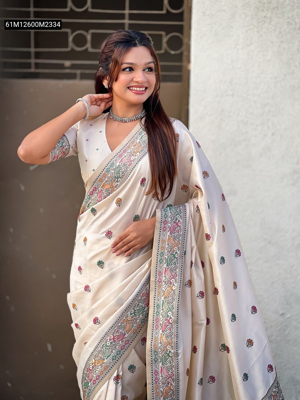 Elegant model posing in a Cream Soft Silk Saree, highlighting the Meenakari border and subtle floral motifs.