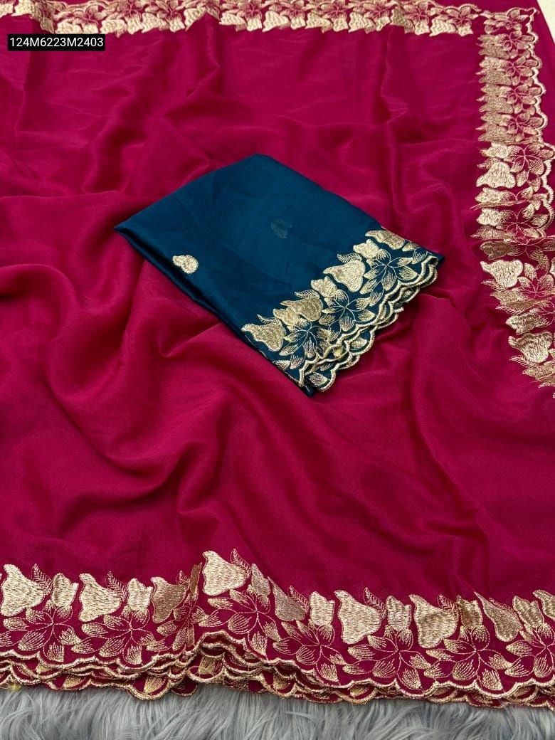TRENDBUY Fuchsia Star Georgette saree with gold floral C-pallu embroidery, displayed with a folded teal contrast blouse piece.