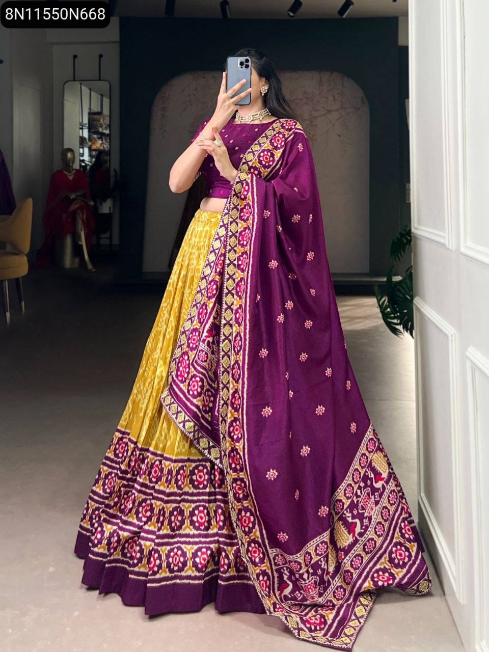 Model in a stunning TRENDBUY Mustard Yellow Ikkat print lehenga with a purple border, paired with a purple blouse and matching sequin embroidered purple dupatta, posing gracefully.