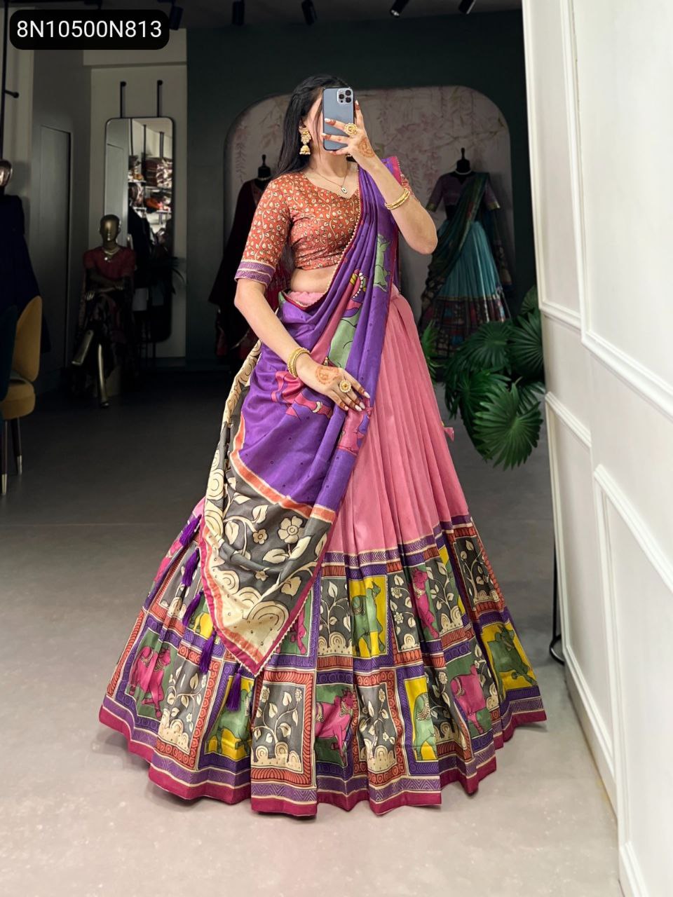 Full body shot of model in TRENDBUY Pink Tasar Silk Kalamkari Lehenga Choli with red printed blouse and purple printed dupatta, showcasing the ensemble.