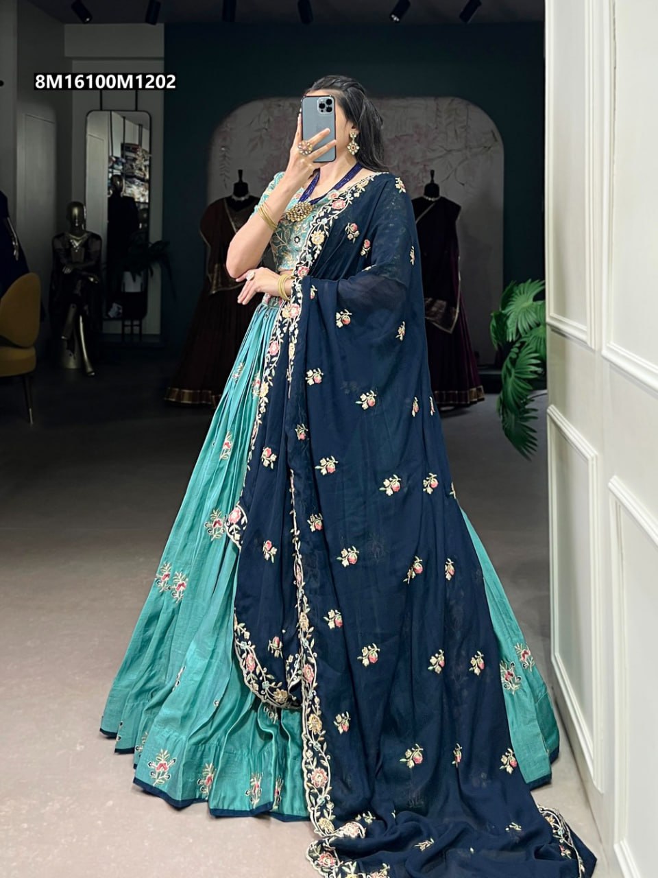 TRENDBUY Teal Embroidered Slab Silk Lehenga Choli with navy blue dupatta, front view, worn by model in an elegant pose, showcasing the full ensemble.