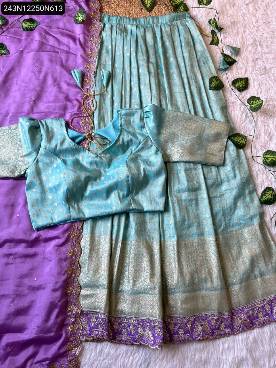 Overhead display of TRENDBUY light blue tissue silk lehenga, blouse, and purple chinnon silk dupatta, showing the full ensemble with embroidered details.