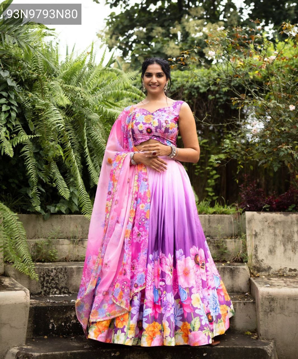 TRENDBUY model in vibrant floral printed Chinon lehenga set, posing elegantly in a lush garden setting.