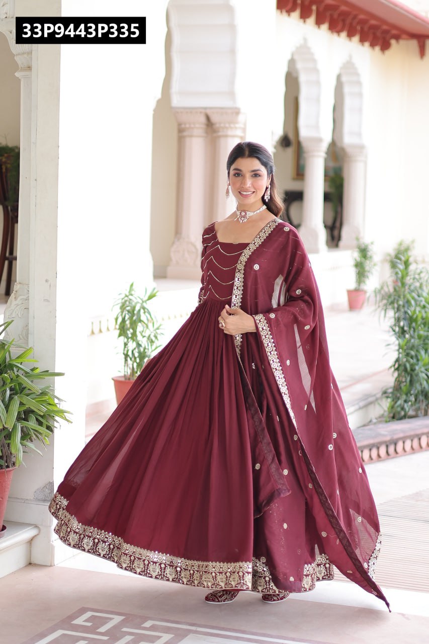 Model in maroon TRENDBUY Vichitra silk gown with sequins and embroidery, twirling to show the flowing 3 MTR flair in an elegant setting.