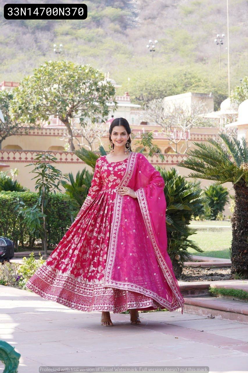 Model twirling playfully in TRENDBUY Pink Viscose Jacquard Gown, showcasing the generous flair and shimmering gold sequin embroidery, against a beautiful garden backdrop.