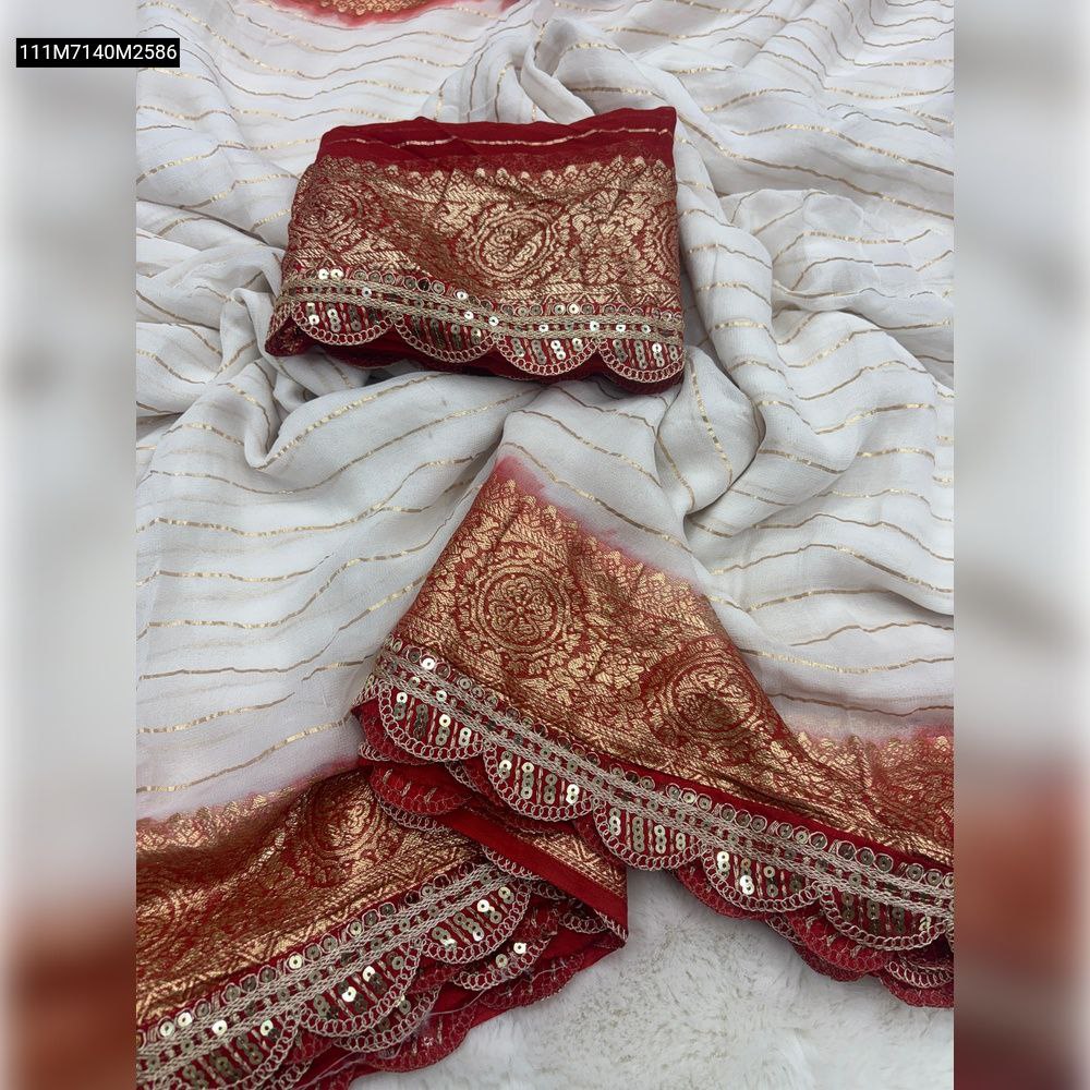 Close-up of TRENDBUY white viscose georgette saree with delicate gold stripes and a vibrant red embroidered border, showcasing sequence work and scalloped edge, paired with a matching folded blouse piece.
