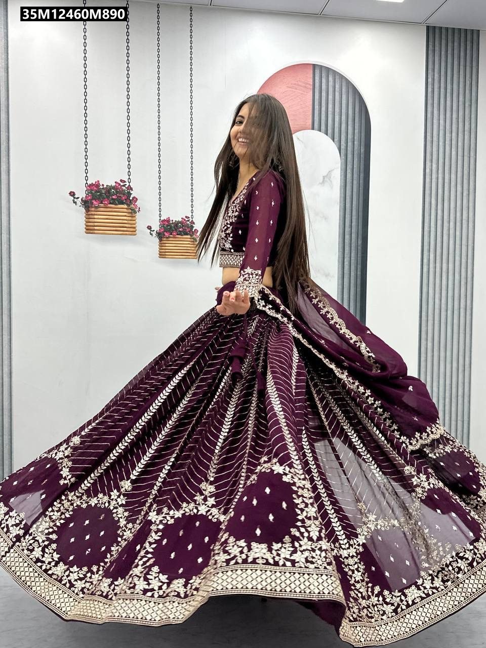 TRENDBUY model twirling gracefully in a Wine Purple embroidered Fox Georgette Lehenga Choli set, showcasing its full flair and intricate sequence work.