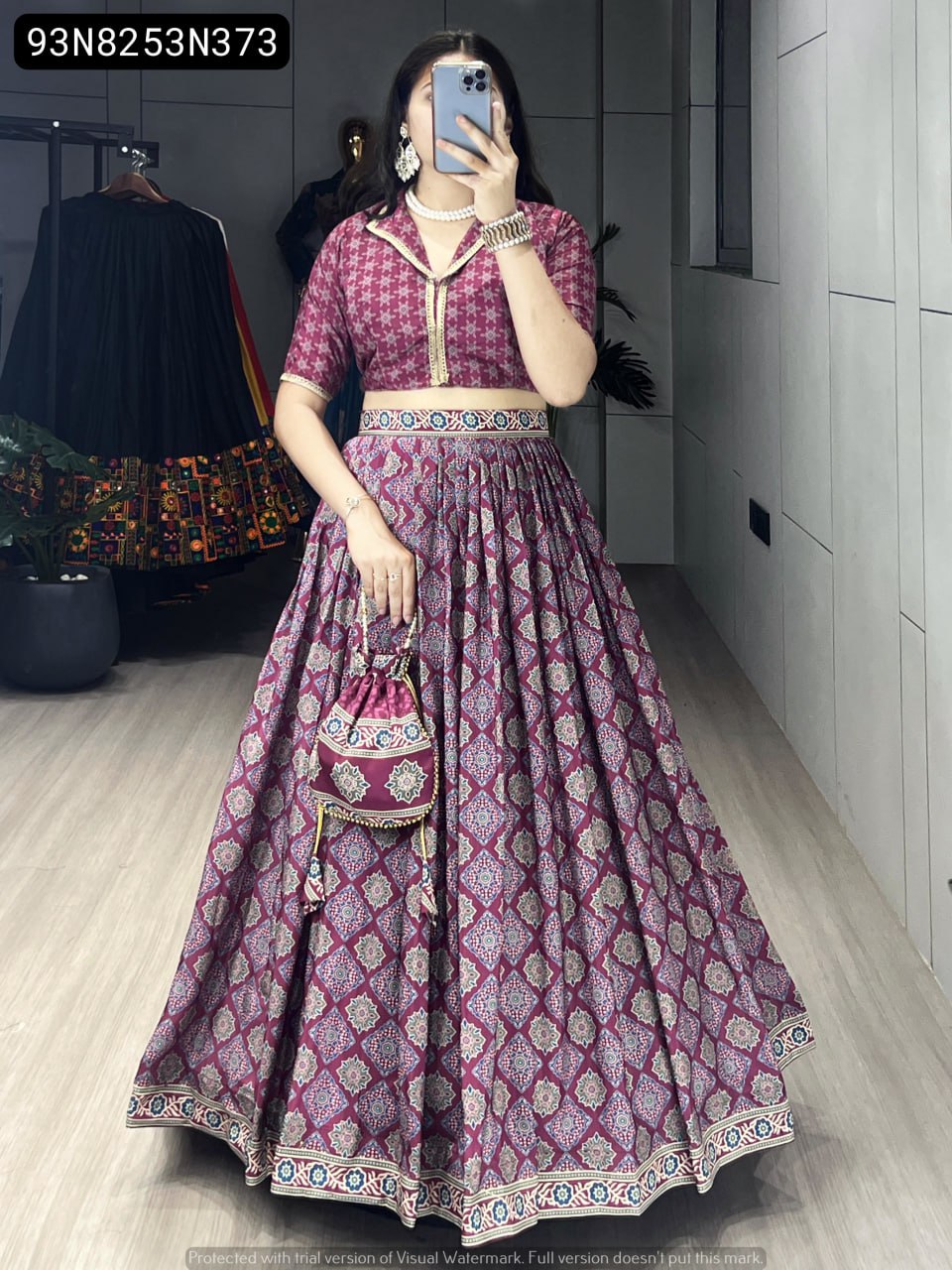 Main product image: A sophisticated model in a full purple Azarakh print silk crape lehenga choli set, complete with a matching potli purse, pearl accessories, and a flattering silhouette.