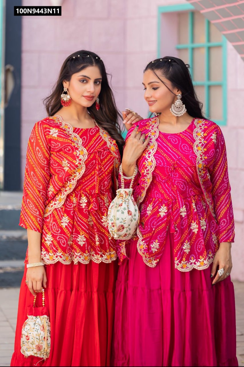Two models showcasing TRENDBUY Bandhej embroidered crop top lehenga sets with jackets, one in vibrant red and one in captivating pink, posing outdoors against a brick wall.
