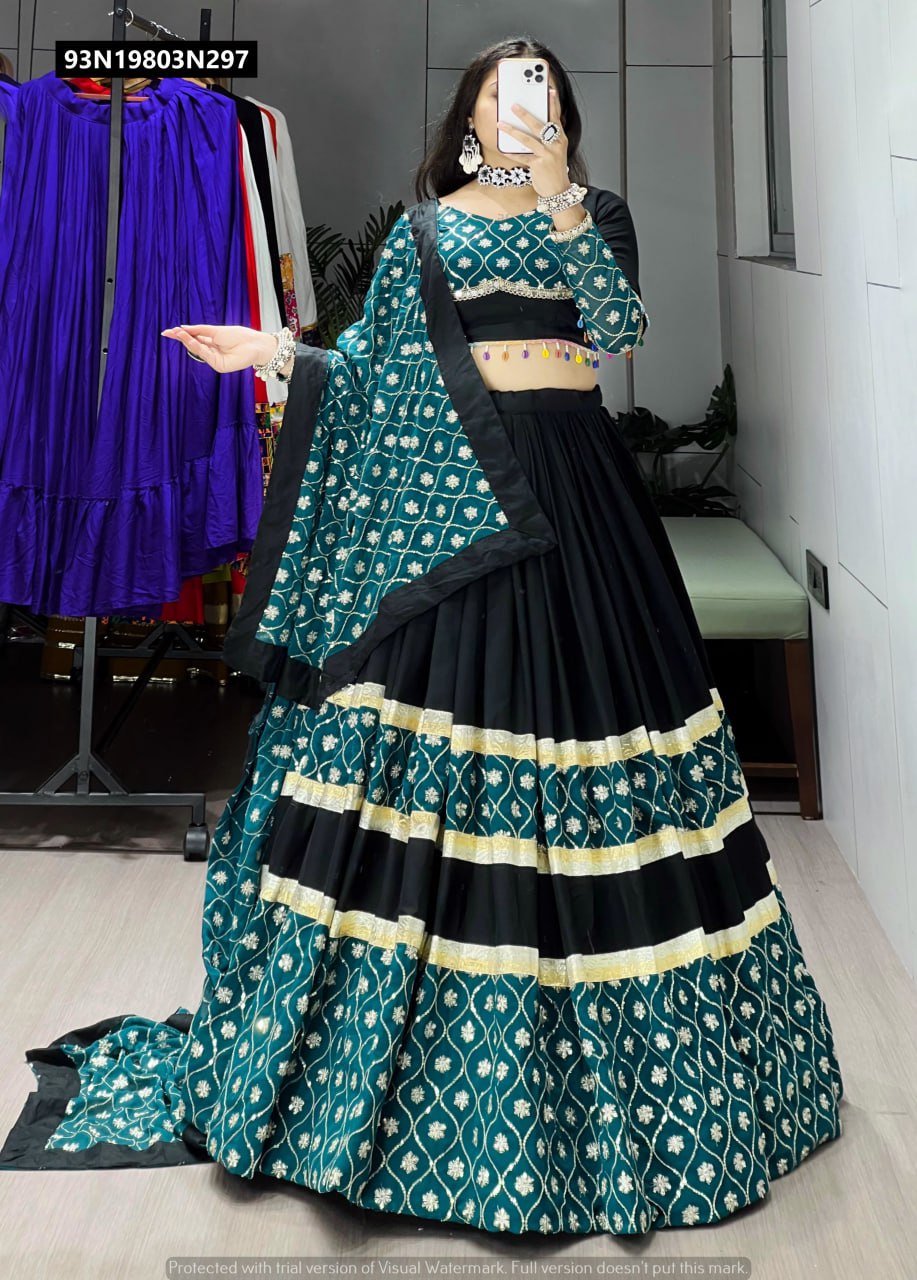 Full body view of TRENDBUY black and teal lehenga choli, featuring a flared skirt with gold gota details and sequence embroidered dupatta, model posing gracefully.