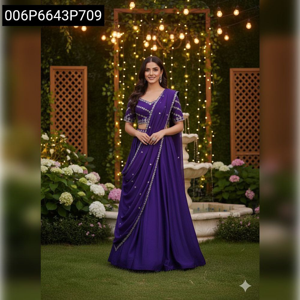 TRENDBUY model in purple embroidered chinnon silk crop top, skirt, and dupatta set, posing elegantly in a garden with string lights and a fountain.