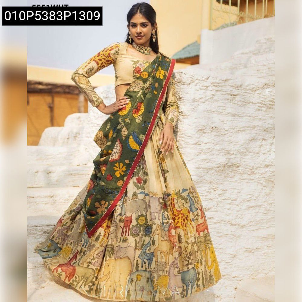 Full shot of a model elegantly posing in the TRENDBUY beige Chinnon Silk Lehenga Choli, adorned with Kalamkari animal print and a dark green floral dupatta, on a textured staircase.