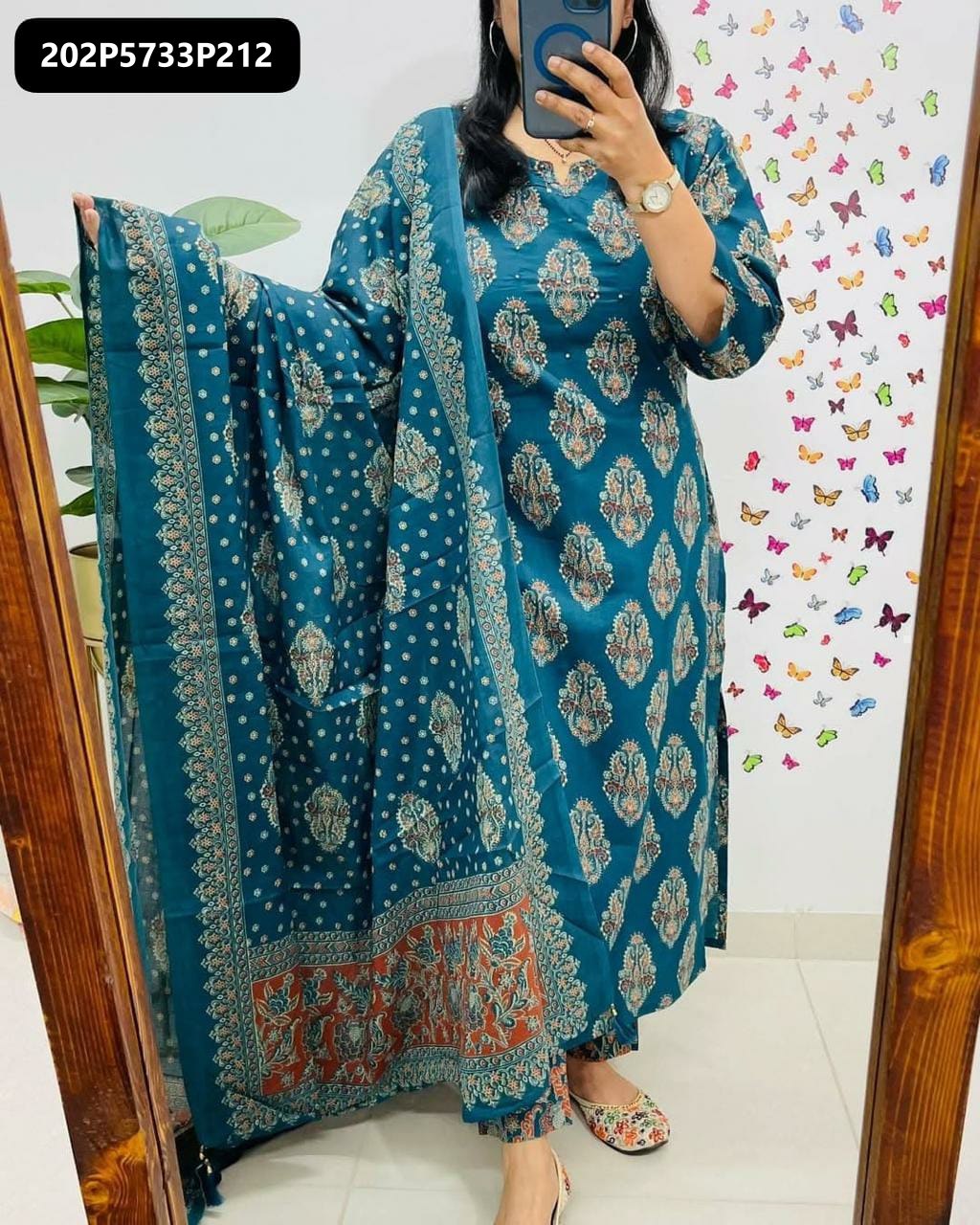 Full body shot of a woman wearing a TRENDBUY teal blue cotton kurta set with printed dupatta and handwork on york, posing in a mirror
