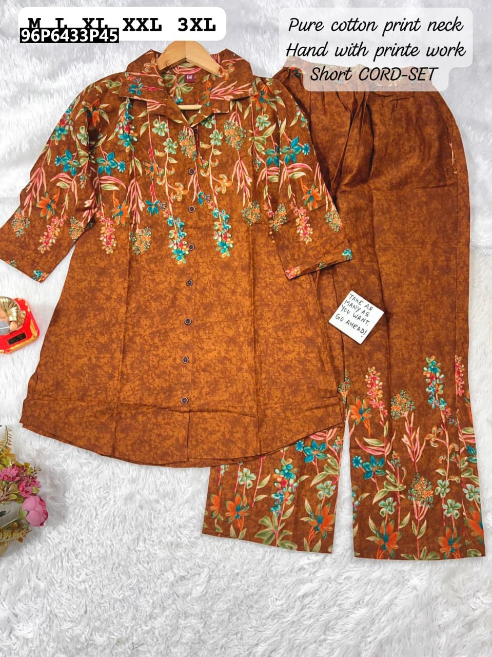 Full flat lay of TRENDBUY women's rust brown floral print cotton co-ord set with V-neck top and matching pants, on a white textured background.