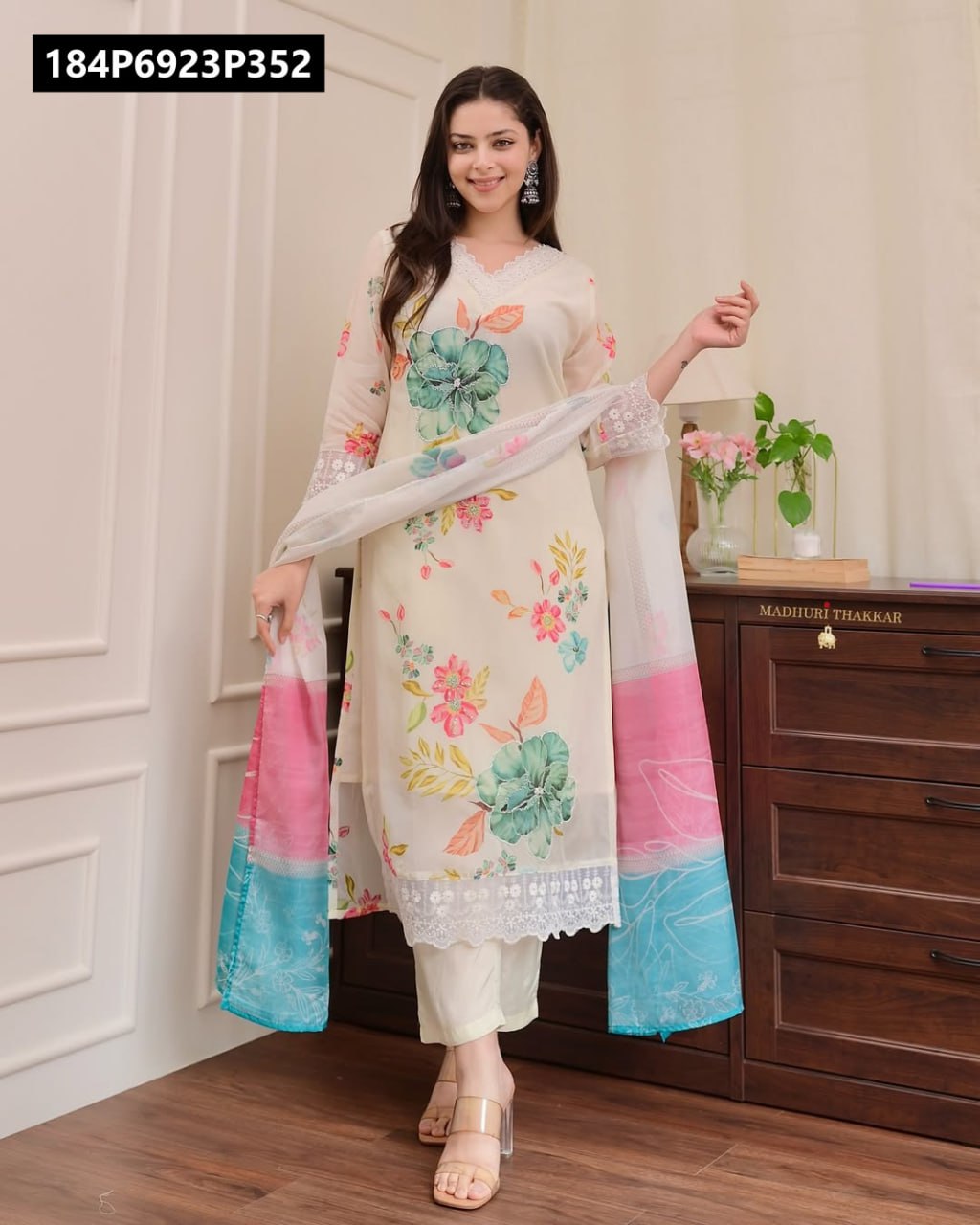 Full body shot of model wearing TRENDBUY cream floral organza kurta pant set with pink and blue border dupatta, smiling.