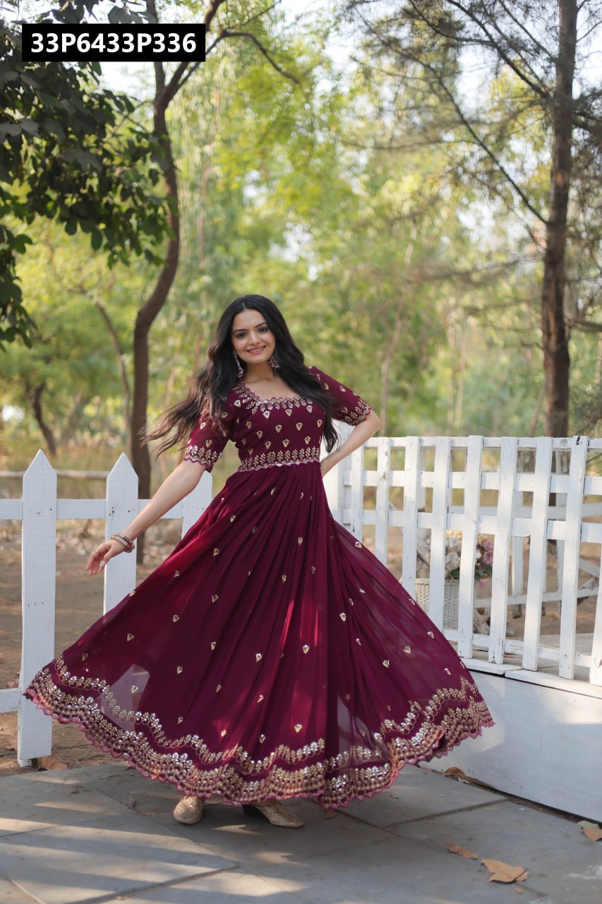 TRENDBUY model in a gorgeous wine faux blooming gown with zari sequins embroidery, twirling gracefully in a garden setting.