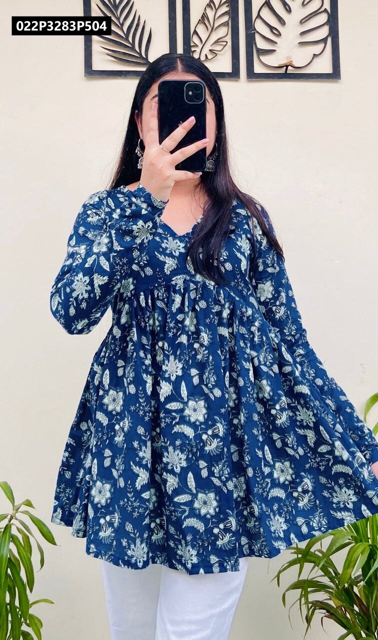 Model showcasing a TRENDBUY Navy Floral Print Cotton Peplum Tunic Top, captured from the side with hands near hips, against a light background.