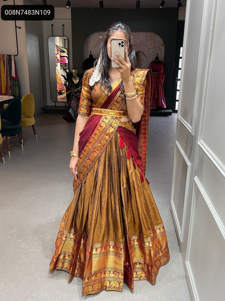 Full-length standing shot of the TRENDBUY model wearing the complete golden-bronze Narayan Pet lehenga choli set, highlighting the expansive 3.40-meter flair of the skirt, rich zari weaving, and the elegant drape of the maroon dupatta.