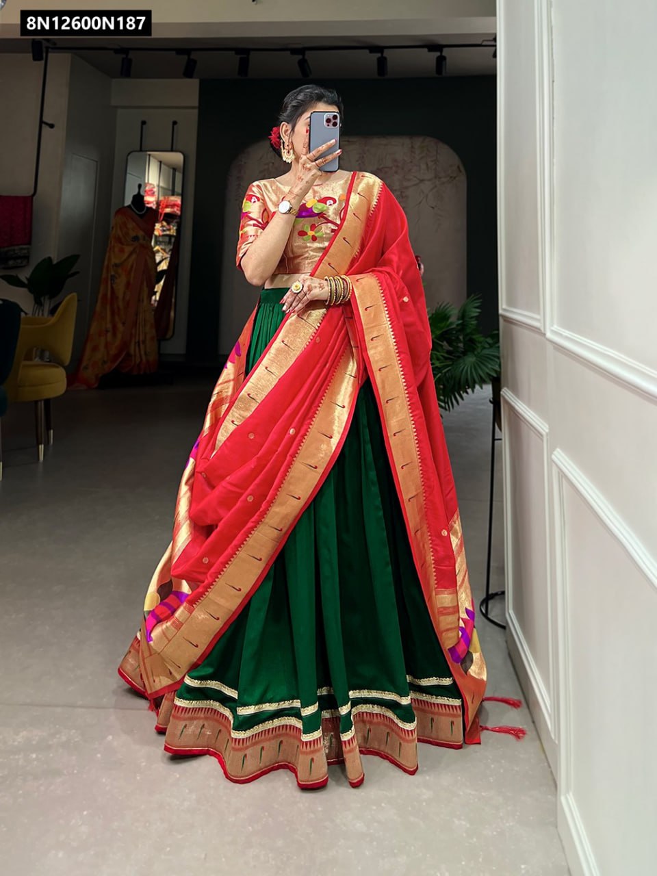 Full body view of a woman wearing TRENDBUY Green Paithani Silk Lehenga Choli with a vibrant red Zari woven dupatta, perfect for festive occasions.