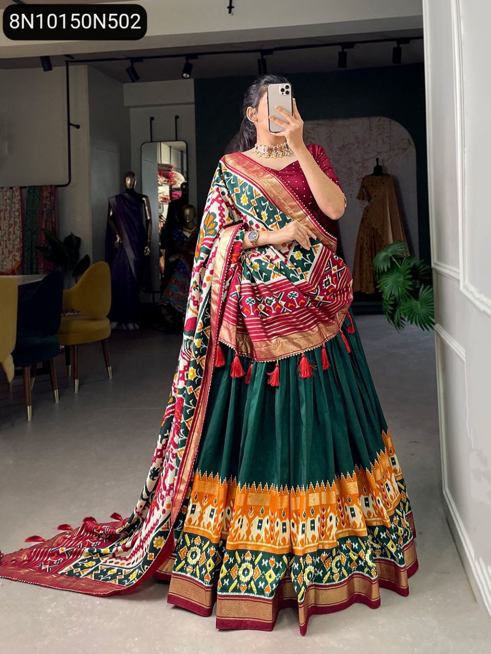 Full shot of model gracefully posing in green TRENDBUY Patola Print Tussar Silk Lehenga Choli with red blouse, full flair visible.