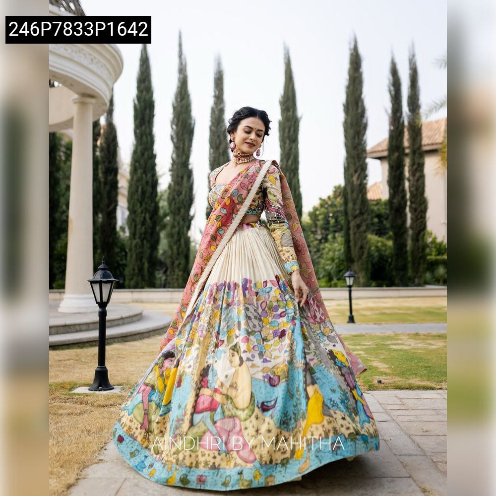 TRENDBUY's elegant multi-color Kalamkari print Tussar Silk lehenga choli set, worn by a model in an outdoor garden setting, showcasing full flair and matching dupatta.