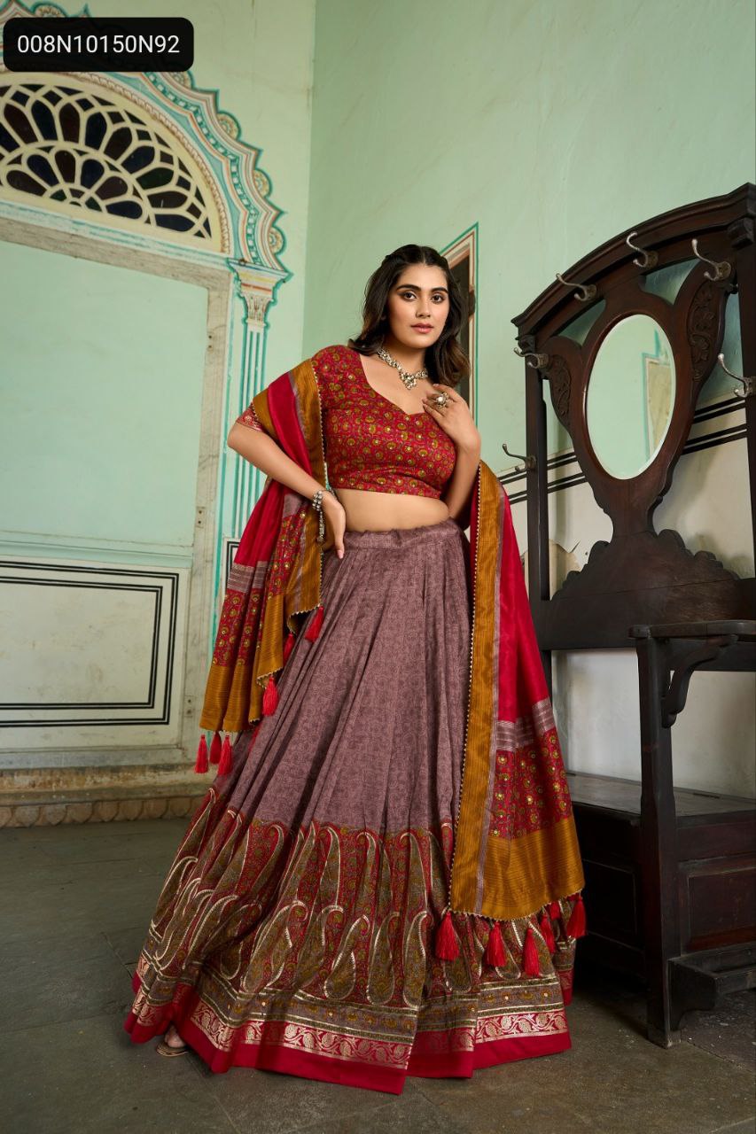 TRENDBUY Women's Red and Mauve Tussar Silk Lehenga Choli featuring Kashmiri and Foil Print, full body shot of model posing elegantly in a traditional Indian setting.