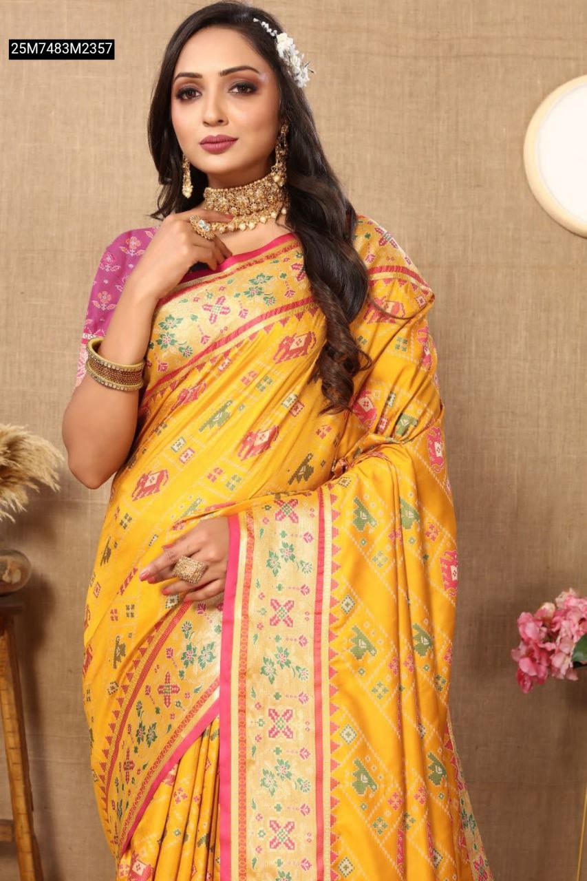 Model gracefully posing in TRENDBUY Yellow Patola silk saree, featuring a vibrant pink Meenakari pallu, traditional jewelry, and elegant drape.