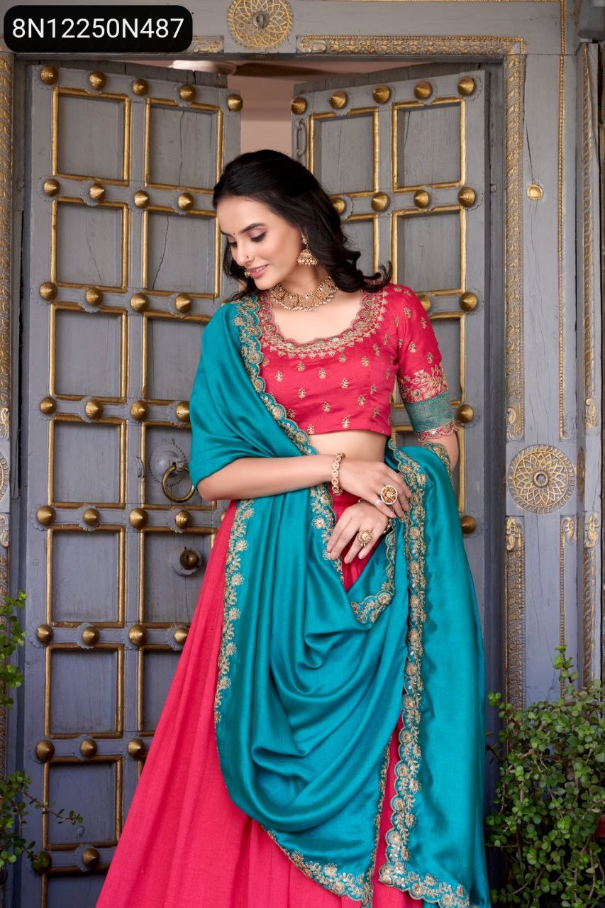 TRENDBUY model in vibrant pink Vichitra silk lehenga with pink blouse and teal zari weaving work dupatta, posing against an ornate wooden door.