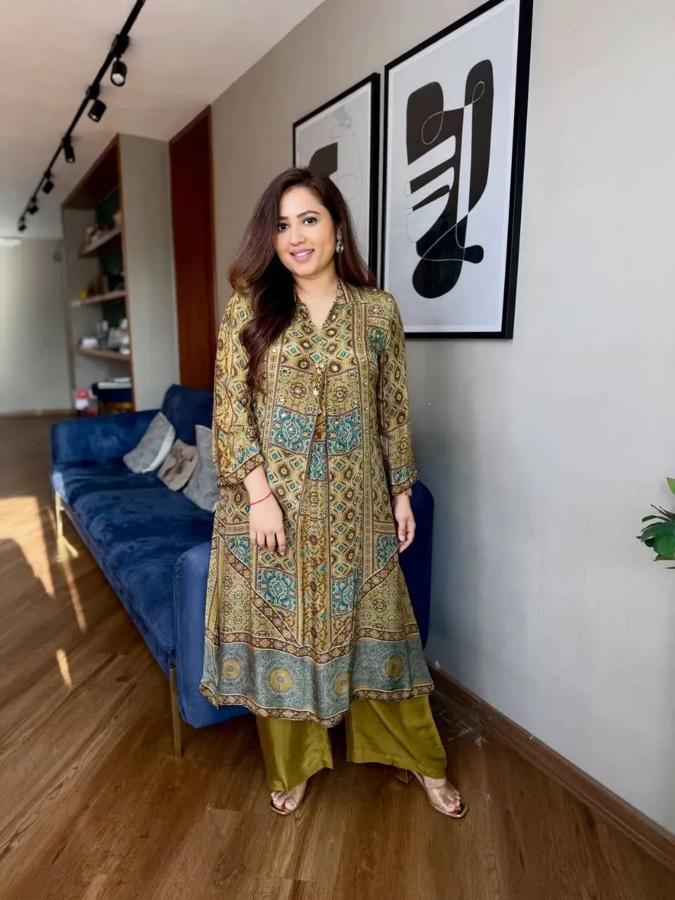 Woman wearing green Ajrakh print crape cord set standing in living room