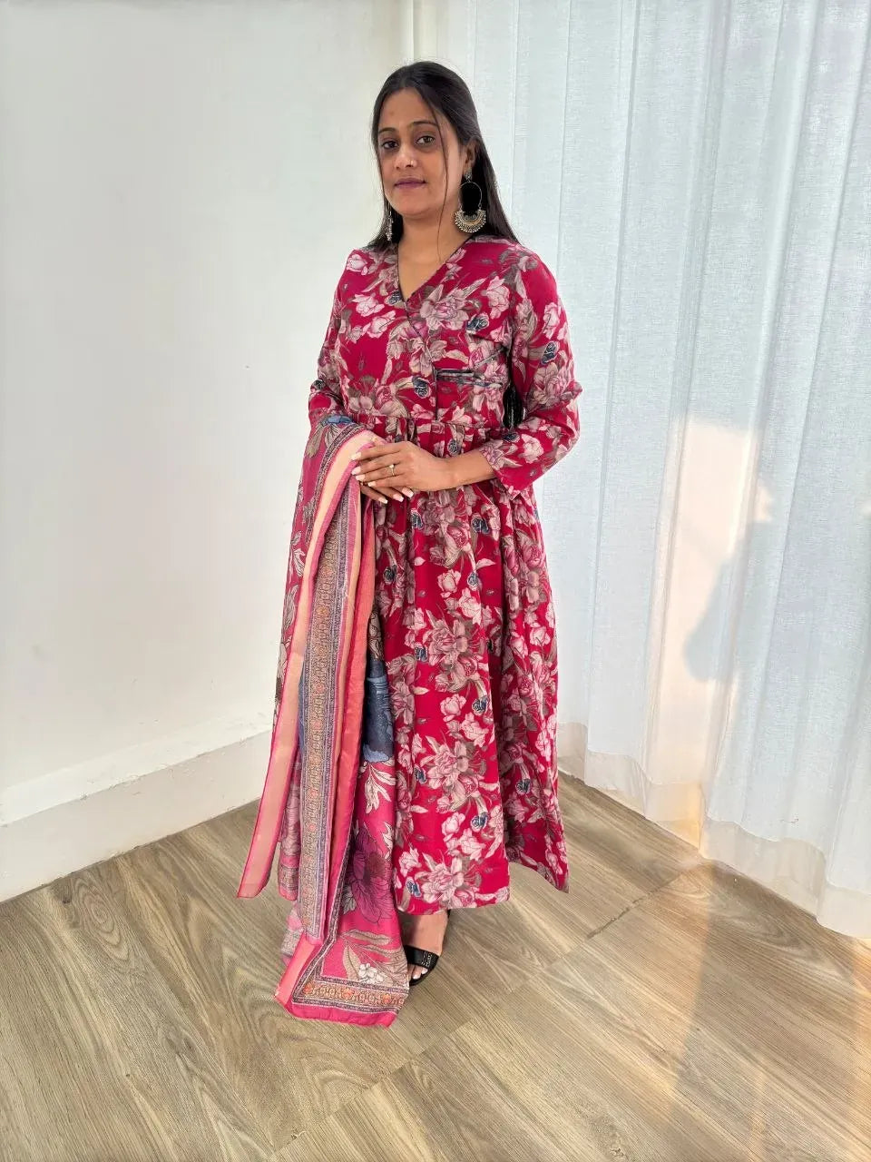 Model standing in pink floral print BSY Roman silk gown holding dupatta