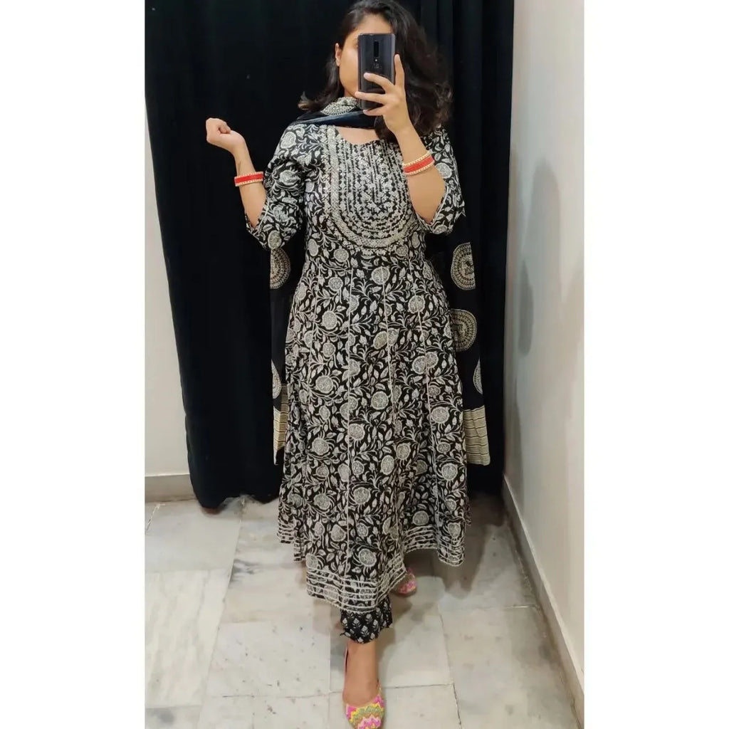 Woman wearing black and white printed rayon cotton gown set with dupatta in front of a mirror