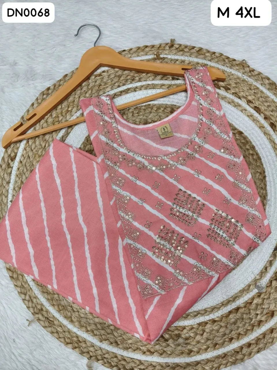 Pink Laheriya slub cotton kurti with sequence work on wooden hanger